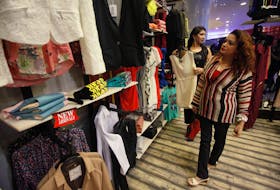 A woman looks at clothes while visiting a shopping mall ahead of Eid al-Fitr in Karachi August 6, 2013.