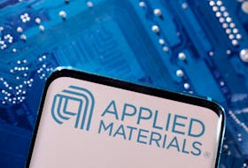 A smartphone with a displayed Applied Materials logo is placed on a computer motherboard in this illustration taken March 6, 2023.