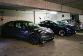 Tesla and Hyundai electric vehicles (EVs) charge at EV charging stations inside a parking garage owned by the City of Baltimore, Maryland, U.S., March 23, 2023.