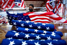 Barbara McClorin inspects U.S. flags made at Valley Forge Flag’s manufacturing facility in Lane, South Carolina, U.S., February 22, 2024.