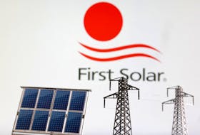 Miniatures of solar panel and electric pole are seen in front of First Solar logo in this illustration taken January 17, 2023.