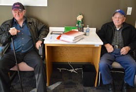 Wayne Musgrave, left, of Frenchvale and Richard Lewis of Edwardsville, wait to pick up their files at the Cape Breton Injured Workers' Association in Sydney Tuesday. BARB SWEET/CAPE BRETON POST