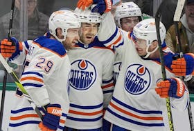 Edmonton Oilers defenceman Evan Bouchard (second from left) celebrates his overtime goal with teammates Leon Draisaitl (10) and Derek Ryan (11) against the Dallas Stars in Dallas on Feb. 17, 2024.