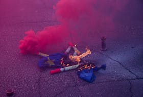 The EU flag burns as Polish farmers protest over price pressures, taxes and green regulation, grievances shared by farmers across Europe and against the import of agricultural produce and food products from Ukraine, in Warsaw, Poland, February 27, 2024.