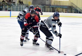 South West Storm forward Zachery D’Arcy (#44) battles for control of the puck with Spryfield Attacker Phillip Ballard (#21) in Nova Scotia Regional Junior Hockey League best of five quarter final series opener action on Feb. 25 in Barrington. Kathy Johnson