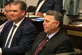 Premier Dennis King, right, sits in the P.E.I. legislature in Charlottetown on Feb. 27, the first day of the winter sitting. King faced questions about the ongoing closure of the PCH ICU from both Opposition and Government MLAs.  Stu Neatby • The Guardian