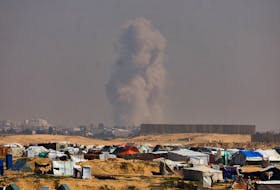 Smoke rises during an Israeli ground operation in Khan Younis, amid the ongoing conflict between Israel and the Palestinian Islamist group Hamas, as seen from a tent camp sheltering displaced Palestinians in Rafah, in the southern Gaza Strip, February 26, 2024.