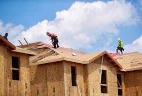 Carpenters work on building new townhomes that are still under construction while building material supplies are in high demand in Tampa, Florida, U.S., May 5, 2021. 