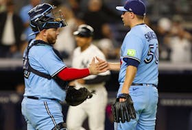 Toronto Blue Jays catcher Alejandro Kirk and relief pitcher Erik Swanson shake hands after defeating the New York Yankees last year.