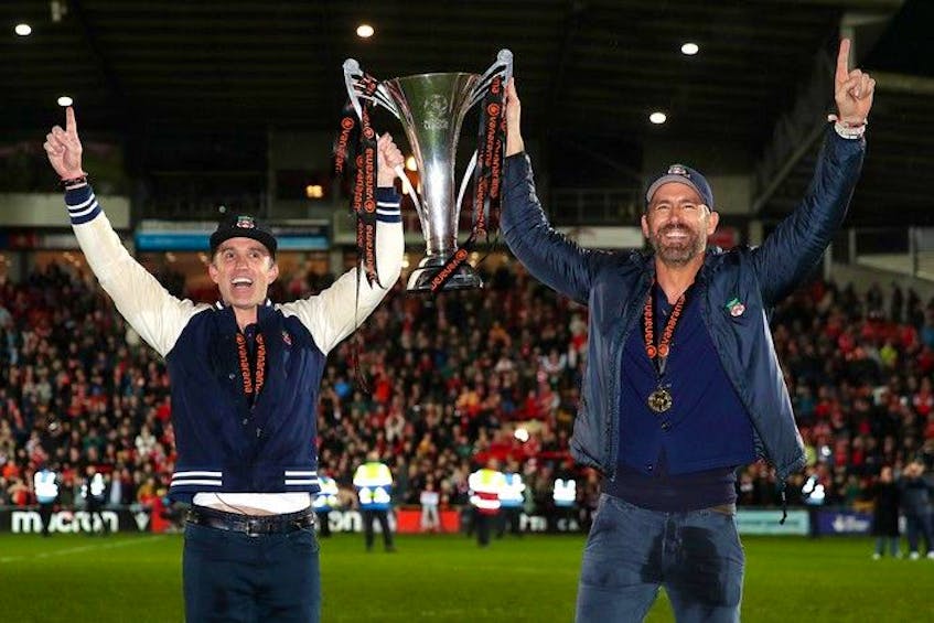  Wrexham co-owners Rob McElhenney and Ryan Reynolds celebrate with the Vanarama National League on April 22, 2023.