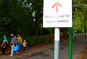 Migrants leave the arrival center for asylum seekers at Berlin's Reinickendorf district, Germany, October 6, 2023.