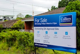 A ÒFor SaleÓ sign is displayed in front of a row of houses in the suburb of Carlingford, Sydney, Australia February 1, 2019. Picture taken February 1, 2019. 