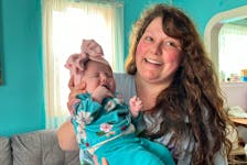Kayliegh Nickerson smiles as she holds her daughter Elsie in her Woods Harbour home. Born on Jan. 2, Elsie had open heart surgery when she was two weeks old. Kathy Johnson