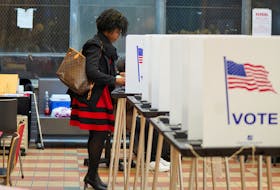 A woman votes at a voting site as Democrats and Republicans hold their Michigan primary presidential election, in Detroit, Michigan, U.S. February 27, 2024.