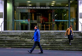 Pedestrians walk near the main entrance to the Reserve Bank of New Zealand located in central Wellington, New Zealand, July 3, 2017. Picture taken July 3, 2017.  