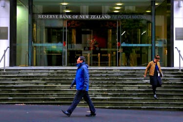 Pedestrians walk near the main entrance to the Reserve Bank of New Zealand located in central Wellington, New Zealand, July 3, 2017. Picture taken July 3, 2017.  