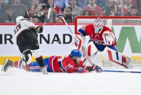 Canadiens' David Savard slides across the ice to try to block the shot of Coyotes' Matias Maccelli as Montreal goaltender Sam Montembeault squares to the shooter Tuesday night at the Bell Centre. 