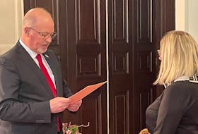 Newly minted MHA Fred Hutton (left) is sworn into a cabinet by Lt.-Gov. Judy Foote on Thursday, Feb. 29. Hutton will take on the housing portfolio.