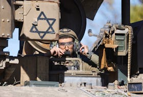 An Israeli soldier looks out from an armoured personnel carrier after returning from the Gaza strip, amid the ongoing conflict between Israel and Palestinian Islamist group Hamas, in southern Israel, February 29, 2024.