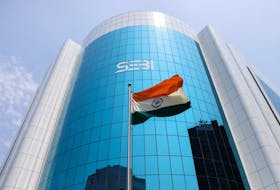 The Indian flag flies in front of the new logo of the Securities and Exchange Board of India (SEBI) at its headquarters in Mumbai, India, April 19, 2023.