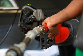 A gas station attendant pumps fuel into a customer's car at the NNPC Mega petrol station in Abuja, Nigeria March 19, 2020.