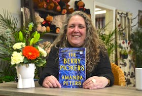 Author Amanda Peters with her award-winning book, The Berry Pickers, after a recent book reading at a flower shop in Wilmot.   
Lawrence Powell • Special to the Annapolis Valley Register
