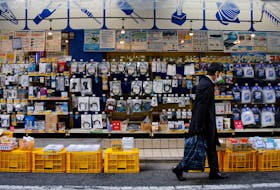 A man walks in front of an electronics store in Tokyo, Japan, January 10, 2017. Picture taken January 10, 2017. 