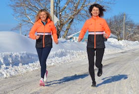Donna Burns, left, and Kathy Sparling, both of Sydney, run down a slush-covered road before leaving for Japan to participate in the annual Tokyo Marathon. With running the marathon, Burns and Sparling will complete the Major Marathons Challenge and earn the prestigious Six Star Medal. GREG MCNEIL/CAPE BRETON POST