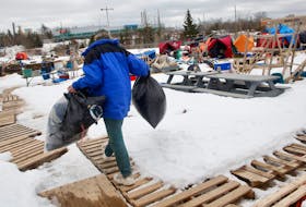 A camp resident carries some of their belongings ahead of the soon to be closed, designated encampment in a ballfield in Lower Sackville Monday February 26, 2024.

TIM KROCHAK PHOTO