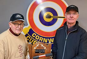 P.E.I.’s men's stick curling champions Clair Sweet, left, and Bob Matheson, who are from the West Prince Curling Club, hold the championship trophy after winning their third title together. Curl P.E.I. • Special to The Guardian