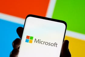 Smartphone is seen in front of Microsoft logo displayed in this illustration taken July 26, 2021.