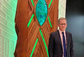 Assistant Governor Christian Hawkesby stands with an art installation of Maori forest god Tane Mahuta at the lobby of New Zealand's Central Bank building in Wellington, New Zealand September 22, 2021.