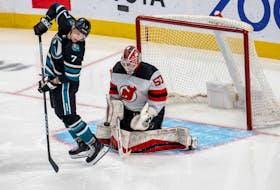 Feb 27, 2024; San Jose, California, USA;  New Jersey Devils goaltender Nico Daws (50) makes a save as San Jose Sharks center Nico Sturm (7) tries to deflect the puck into the net during the third period at SAP Center at San Jose. Mandatory Credit: Neville E. Guard-USA TODAY Sports/ File Photo