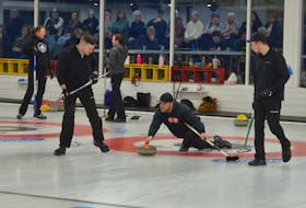 Skip Tyler Smith makes a shot while second stone Chris Gallant, left, and lead Edward White, right, are ready to handle the sweeping chores during the P.E.I. Tankard men’s curling championship in Summerside on Jan. 27. Smith went 6-0 in the provincial championship to earn P.E.I.’s berth at the Montana’s Brier Canadian men’s curling championship in Regina, March 1-10. Jason Simmonds • The Guardian