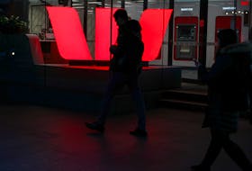 Pedestrians walk past the ground floor of an office building with Westpac logo in the Central Business District of Sydney, Australia, June 3, 2020.