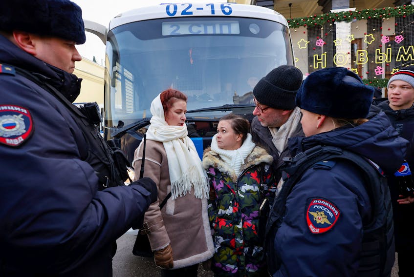 Members of the women's movement "Way Home", including activist Maria Andreeva, demanding the return of their husbands who joined the Russian armed forces involved in a military campaign in Ukraine, stand surrounded by police officers during a gathering in central Moscow, Russia, February 3, 2024.