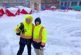 Stephen Wilsack, left, and Matthew Grant are shown at a camping site in front of Halifax City Hall on Sunday. They've been there for the last 90 days trying to meet people’s basic needs.