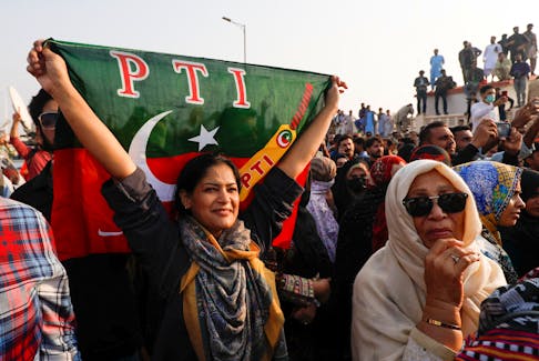 A supporter of Pakistan Tehreek-e-Insaf (PTI) waves the party flag during a rally ahead of the general elections in Karachi, Pakistan January 14, 2024.