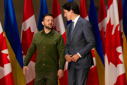 Ukrainian President Volodymyr Zelenskyy, left, and Prime Minister Justin Trudeau talk before a joint press conference on Parliament Hill in Ottawa on Sept. 22, 2023. 