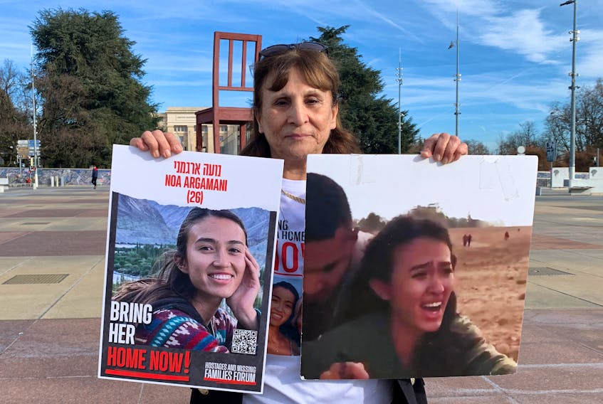 Yaffe Ohad, aunt of Noa Argamani who was taken hostage by Hamas militants during the October 7 attack, poses with posters in front of the United Nations European headquarters in Geneva, Switzerland, February 6, 2024.