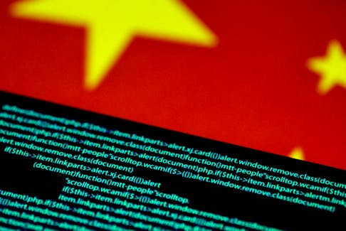 Computer code is seen on a screen above a Chinese flag in this July 12, 2017 illustration photo.  