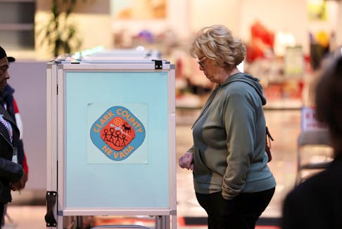 A voter casts her ballot in the state's Democratic and Republican presidential primary election, held two days before a competing Republican presidential caucus, in Las Vegas, Nevada, U.S. February 6, 2024. 