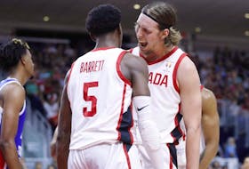 Canada's RJ Barrett celebrates his basket with Kelly Olynyk during a game in 2018.