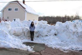 Morgan MacMullin stands outside of her home in Florence with a large pile of snow and ice blocking access to the driveway. She said a snowplow left the pile there after clearing her street earlier this week and was a hazard for anybody carrying groceries or other supplies over it on foot. Snow-clearing crews returned to remove the pile on Thursday, about two days after it appeared. LUKE DYMENT/CAPE BRETON POST