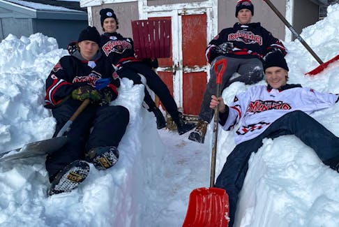 The Glace Bay Miners U18 'AA' hockey team players who were able to get out of their homes to help shovel people out on Monday on top of the walkway they made to a woman's shed, which she needed to get wood for heat in her home. Pictured here in the front from left are Mitchell Jenkins and Ryan MacNeil. In the back from left are Vance McPhee and Logan Roper. CONTRIBUTED