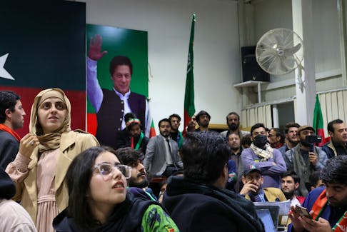 Volunteers for former Prime Minister Imran Khan's party Pakistan Tehreek-e-Insaf (PTI) look on as they watch results on TV screens after the end of the polling during a general election at the party's main office in Islamabad, Pakistan, February 8, 2024.