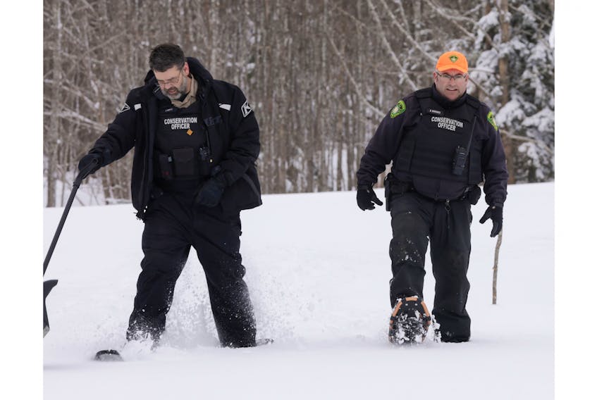 Department  of Natural Resources and Renewables conservation officers Corey Bowen  and Deiter Warwick snowshoe back from a home where the two conducted a  well-being check on a senior who was snowed in. (Communications Nova  Scotia)