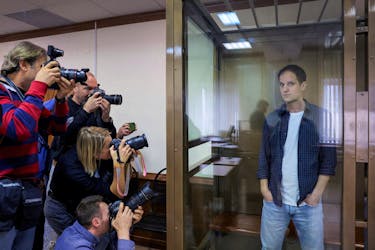 Wall Street Journal reporter Evan Gershkovich stands inside an enclosure for defendants before a court hearing to consider an appeal against his pre-trial detention on espionage charges in Moscow, Russia, October 10, 2023.