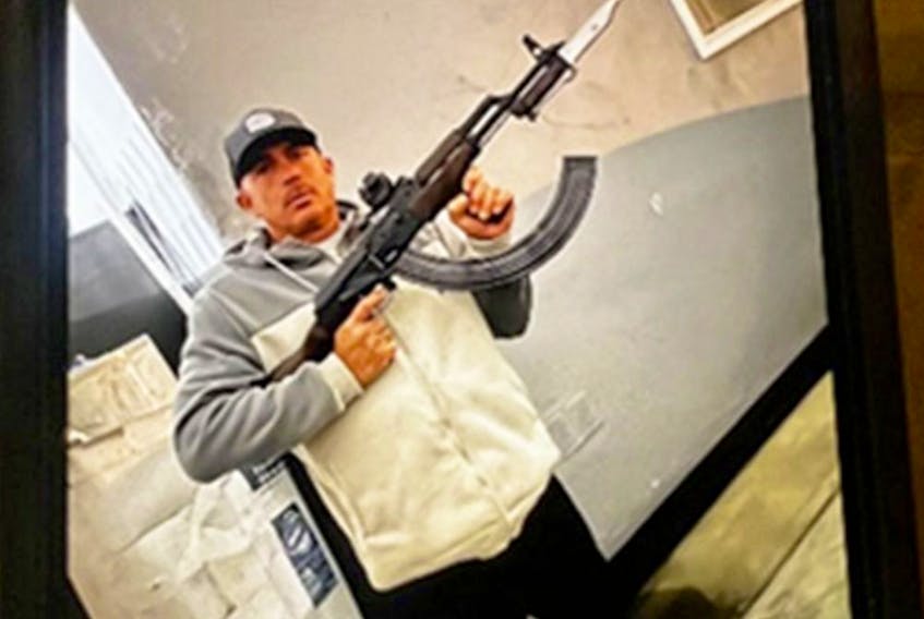  A photo of Carlos Barragan with holding a gun found on his phone.