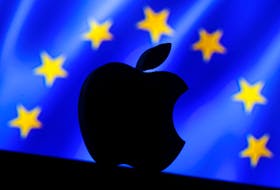 A 3D printed Apple logo is seen in front of a displayed European Union flag in this illustration taken September 2, 2016.
